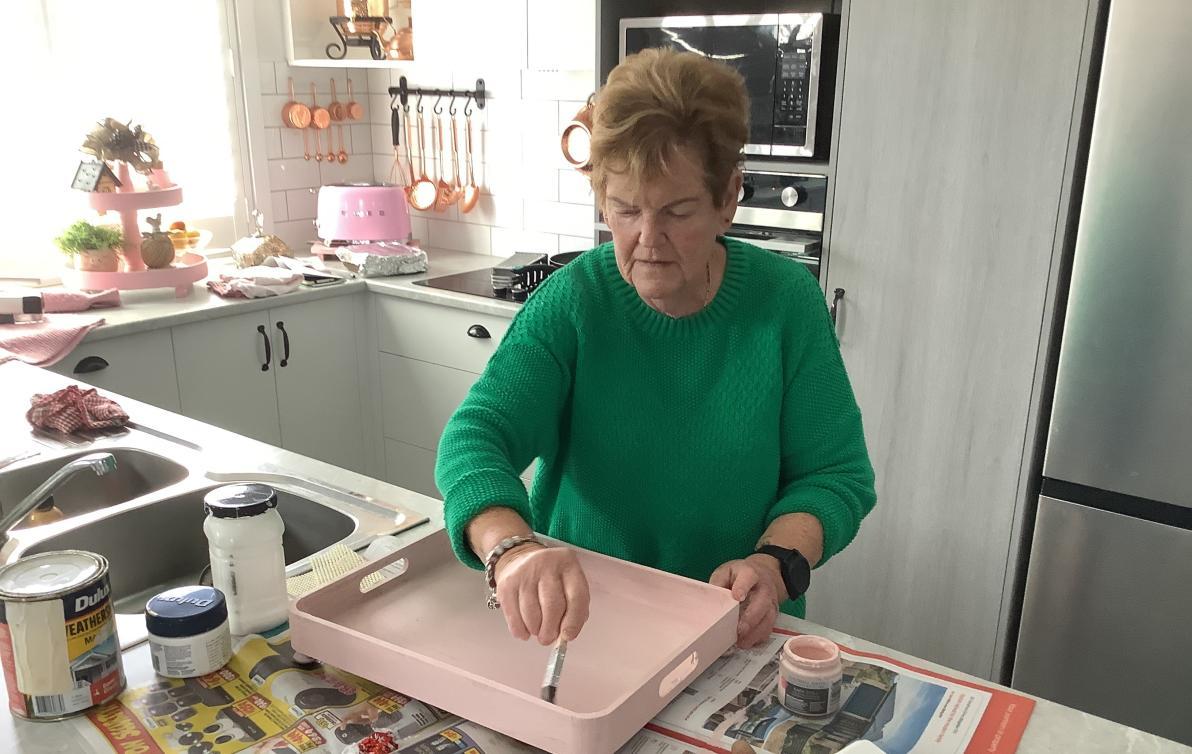Dementia Advocate Jenny painting a tray.