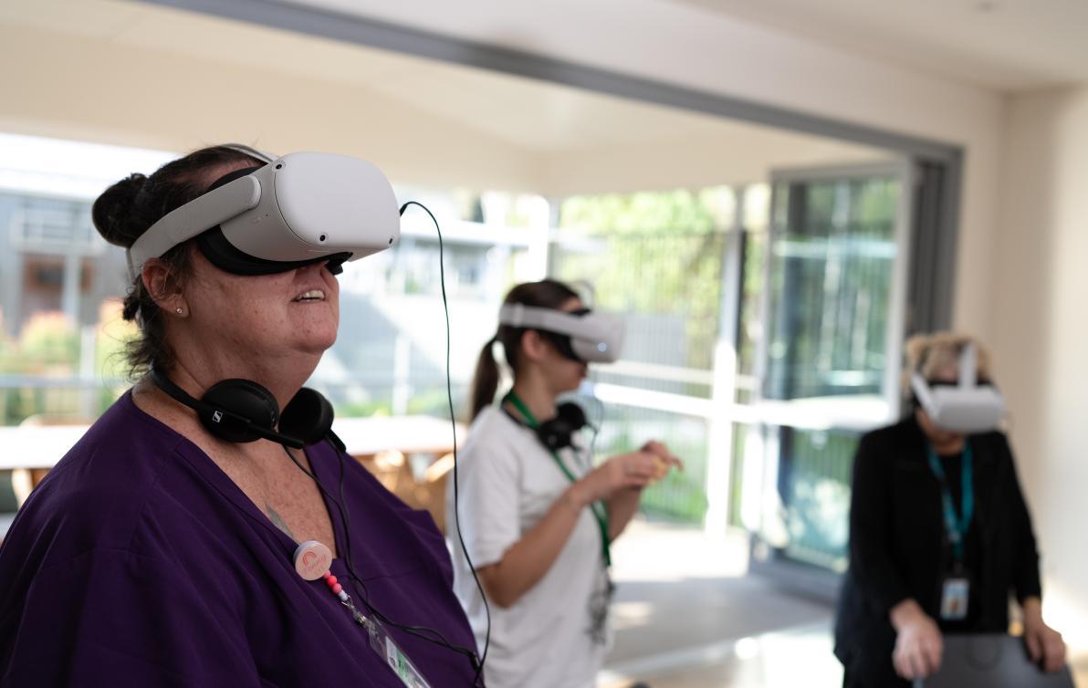 Three people wearing virtual reality headsets.