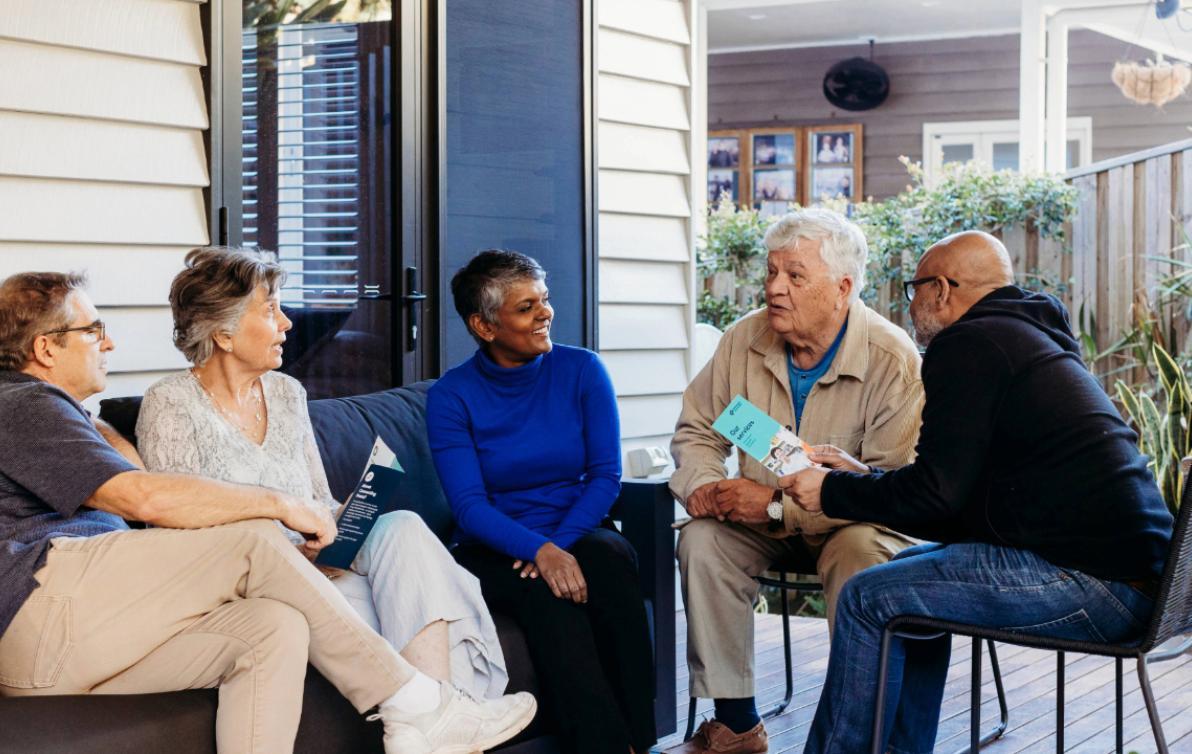 a diverse group of friends having a chat on the porch