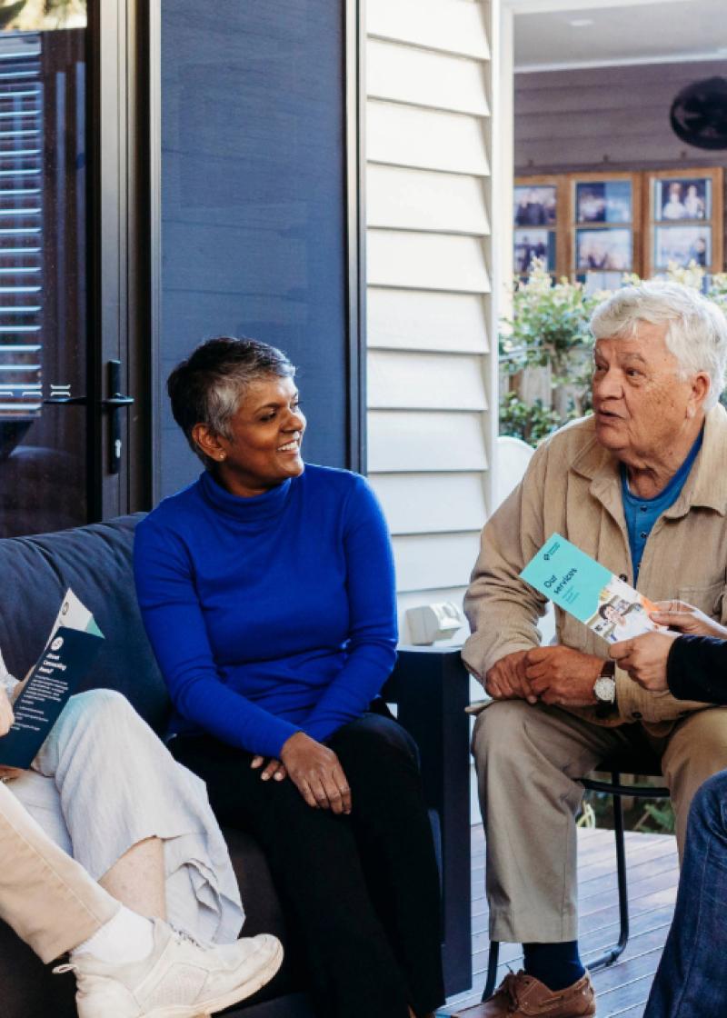 a diverse group of friends having a chat on the porch